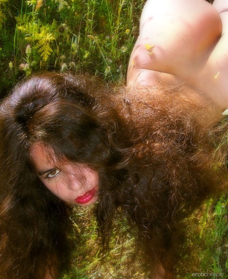 Young girl with a lot of hair on her head Idoia A gets naked in a field 70634473
