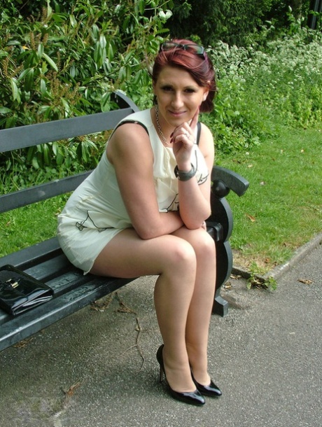 Thick woman in glasses shows off her stiletto heels on a park bench 29970892