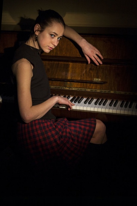 Slim brunette teen Tigra strikes great nude poses on an upright piano 61604674