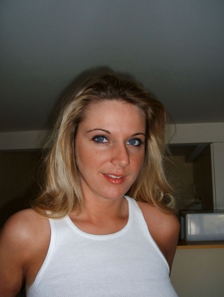 Blonde amateur A J Bailey proudly shows off her firm boobs after getting naked 94186644
