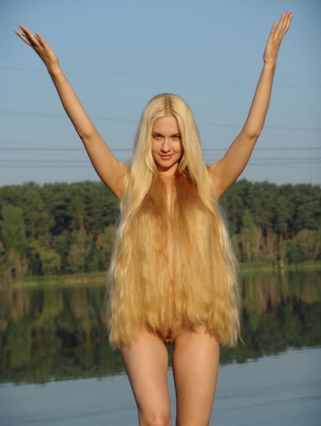 Young girl with long blonde hair poses totally nude at the lake 34083597